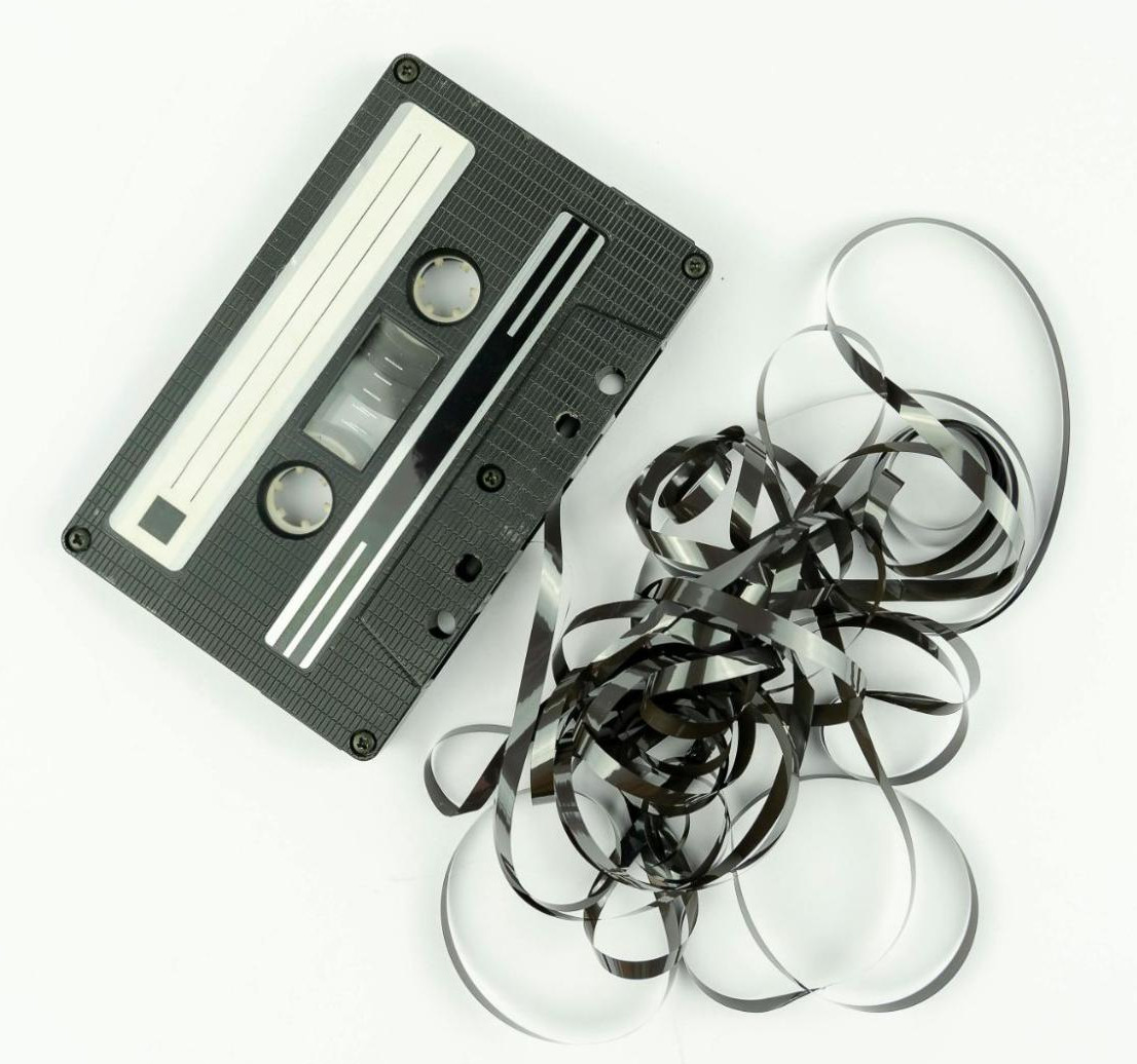 Cassette tape where the tape has been pulled out of the cassette